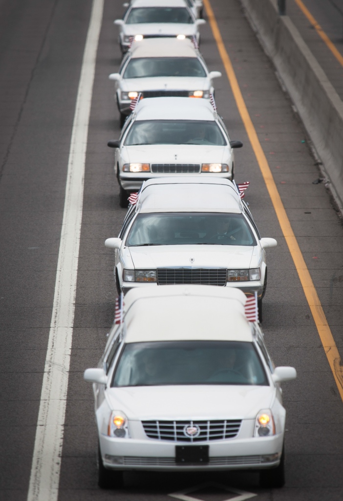 The bodies of the 19 members of the Granite Mountain hotshot crew killed in the Yarnell Hill Fire are escorted from downtown Phoenix back to Prescott along Interstate 17 North on Sunday, July 7, 2013 in Phoenix. (Aaron Lavinsky/The Arizona Republic)